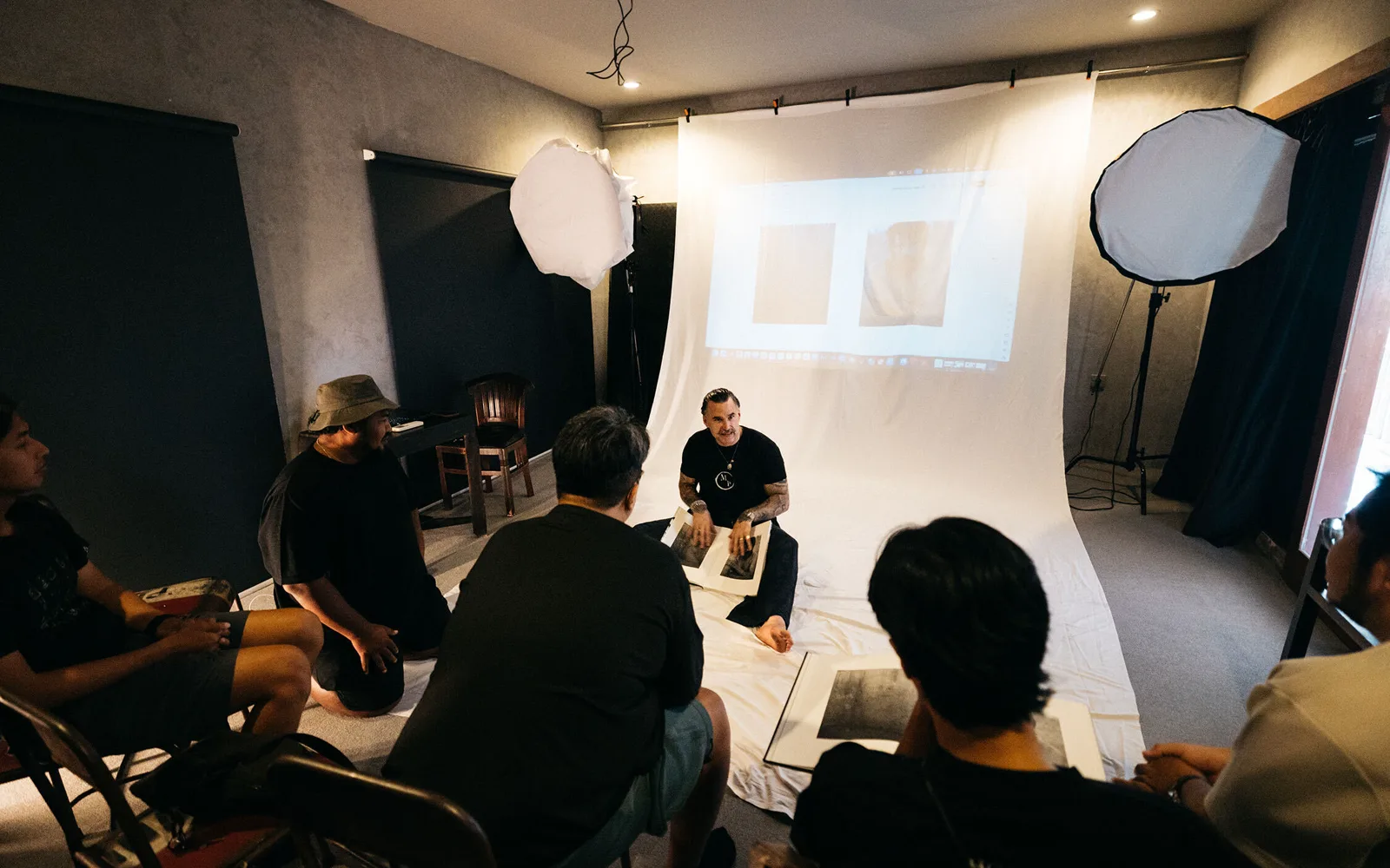 Members gathered in the studio with photobooks for a critique session